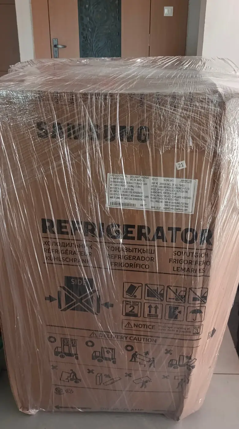 Refrigerator wrapped in corrugated packing for safe house shifting