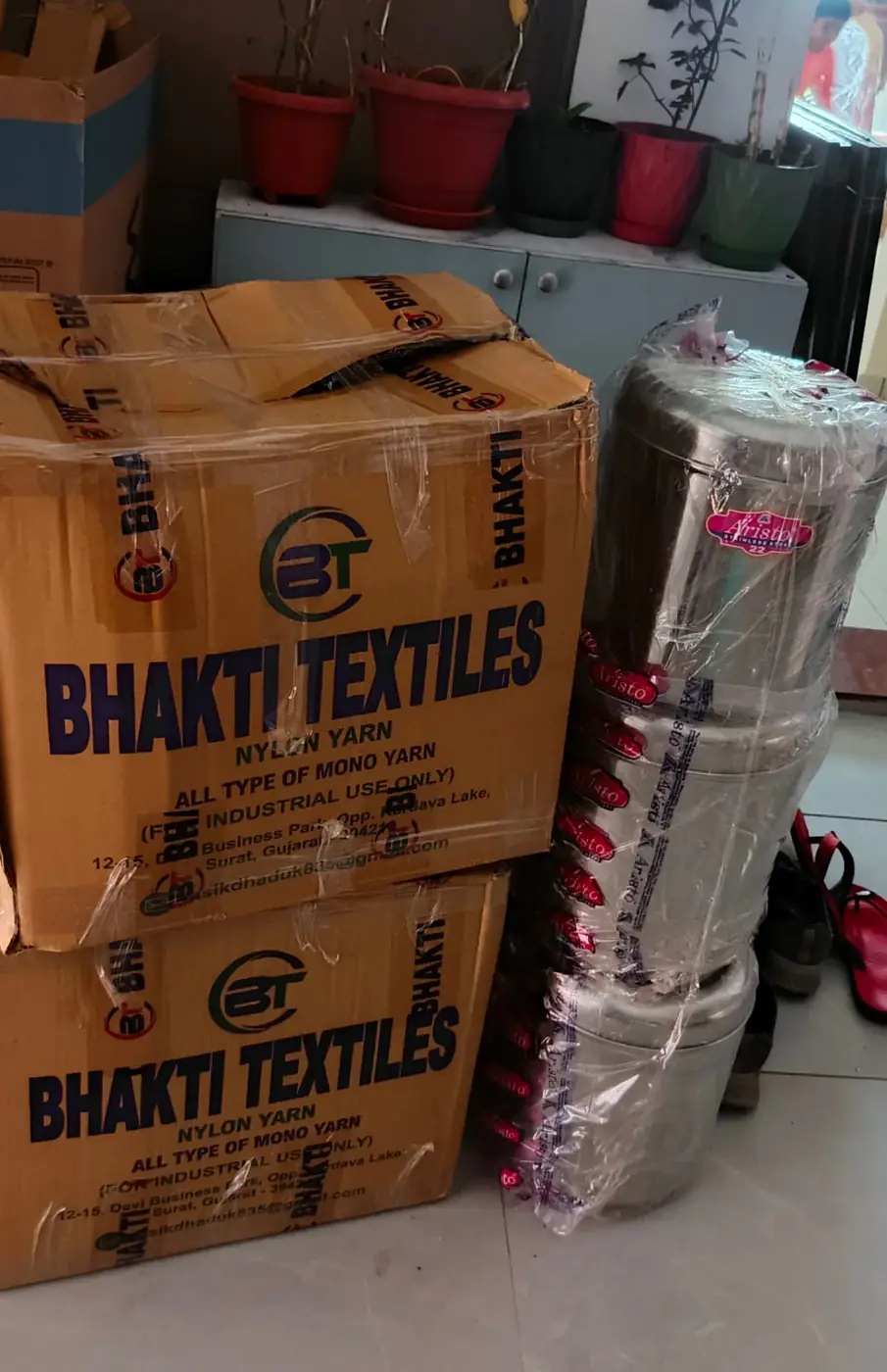 Cartons and kitchen containers packed for a Surat relocation
